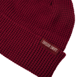 Red, knit beanie with cuff and woven "Taylor Swift" label.