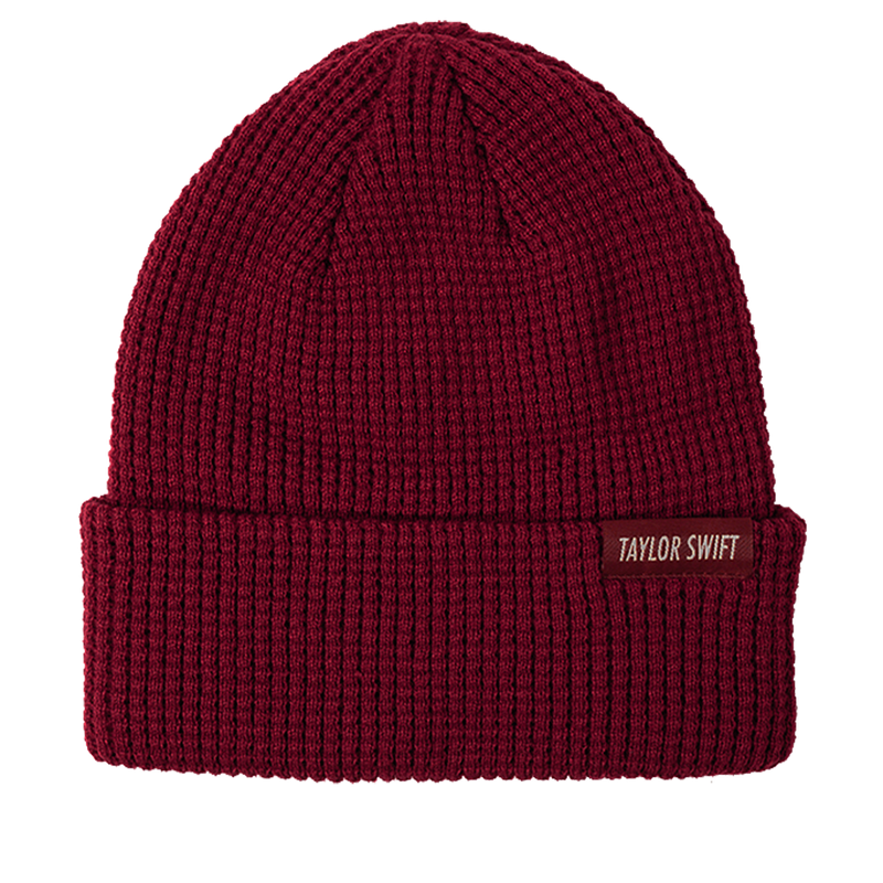 Red, knit beanie with cuff and woven "Taylor Swift" label.